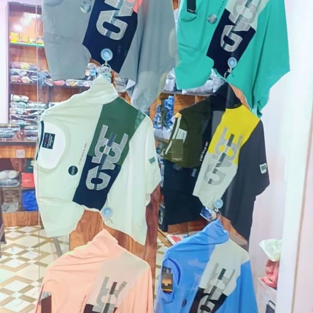 Various, including white, green, black, yellow, peach, blue, and gray. Each shirt has a color-blocked design. T-shirt