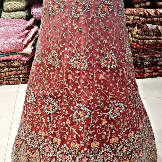 Red with gold, orange, green, and white accents Lehenga