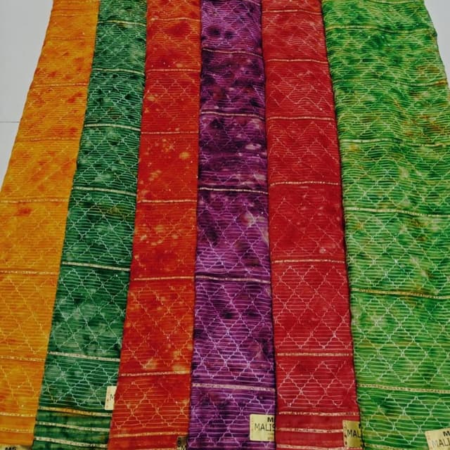Vibrant shades including gold, green, orange, red, and purple. Fabric or Saree