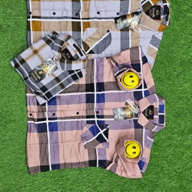 Multi-color, featuring a plaid pattern with hues of pink, black, blue, and white, as well as grey, brown and white variations. Shirt