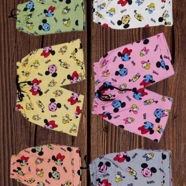 Various pastel colors including yellow, pink, green, peach, white and gray with printed cartoon characters in primary colors. Shorts