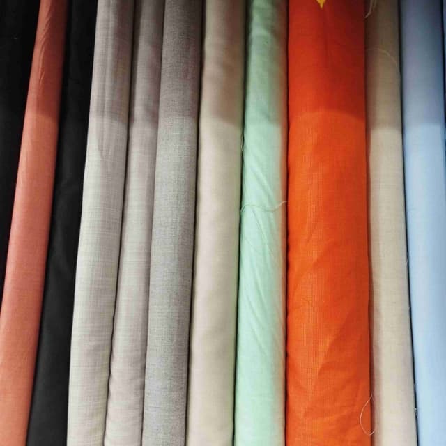 Variety of colors including peach, black, light gray, dark gray, off-white, light green, orange, beige, and light blue. Fabric Rolls
