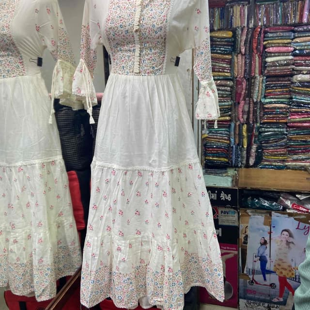 White, with floral patterns in pink, blue, and green Dress