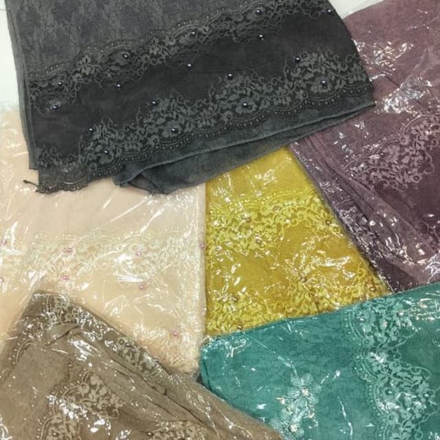 Various, including charcoal grey, soft pink, golden yellow, teal, and mauve. Scarves or Shawls