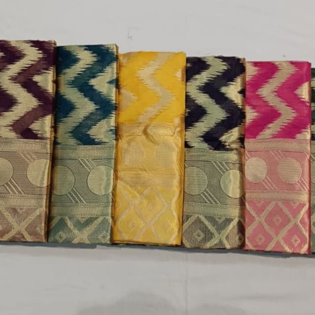 Various, including shades of purple, teal, yellow, navy, and pink with gold accents Saree