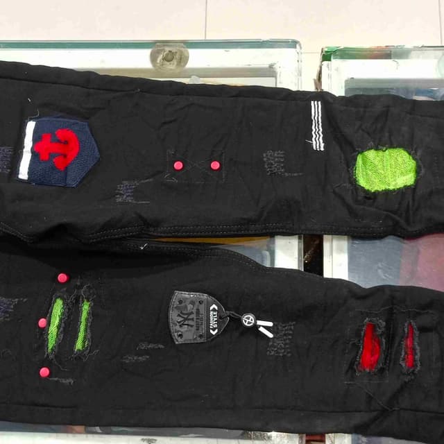 Black with accents of red, green, and white Jeans