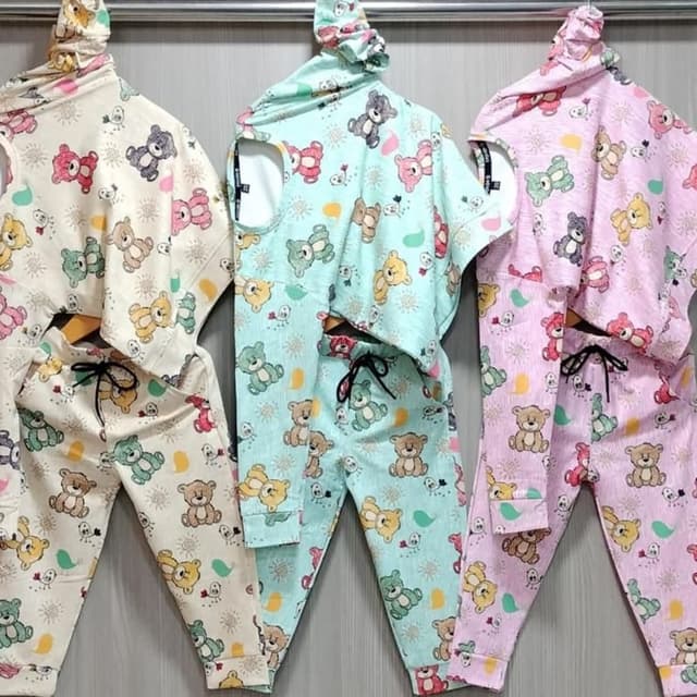 Pastel shades of cream, mint green, and pink with a repeating pattern of multi-colored teddy bears Pajama set