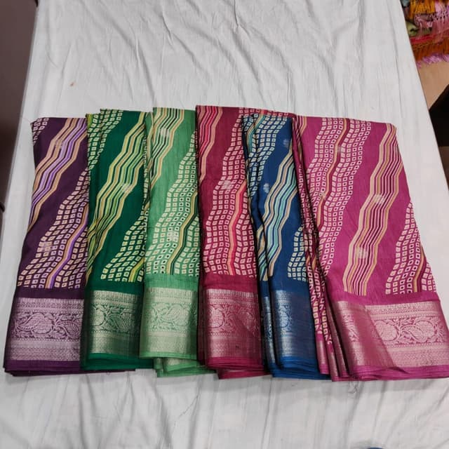 Various, including shades of purple, green, red, blue, and pink. Each saree has a unique color scheme, often with contrasting borders. Saree