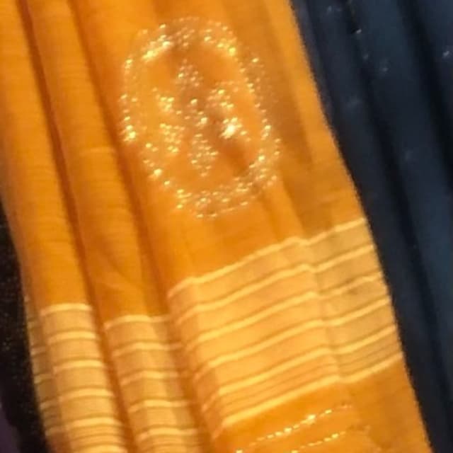 Mustard yellow, white, and hints of a darker color possibly navy blue Saree