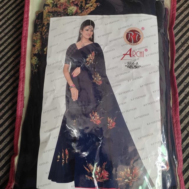 Navy blue with floral prints in shades of red, orange, and gold. Saree