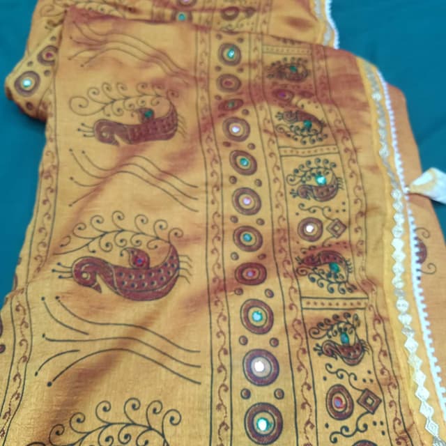 Mustard yellow, brown, and hints of red and green Saree or similar draped garment