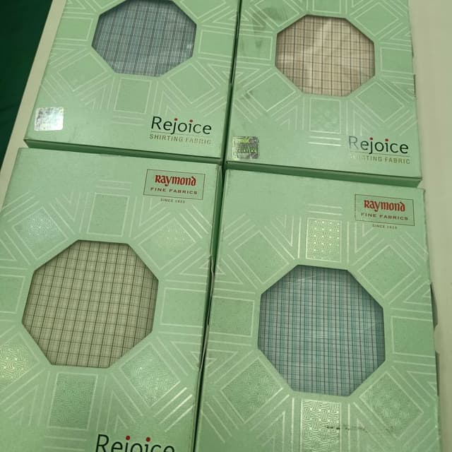Various plaid patterns including blue, beige, and green tones. Shirting Fabric