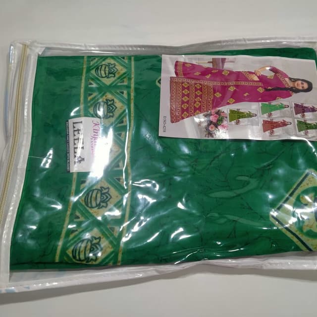 Green, with hints of yellow and a pink blouse Saree