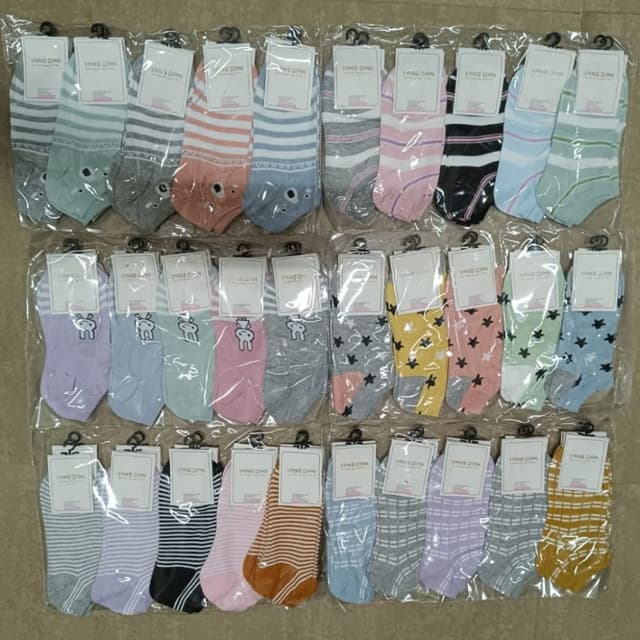 Various pastel colors, including pink, blue, yellow, green, gray, and black, with multiple combinations, also with white or neutral colors like brown and orange. Socks
