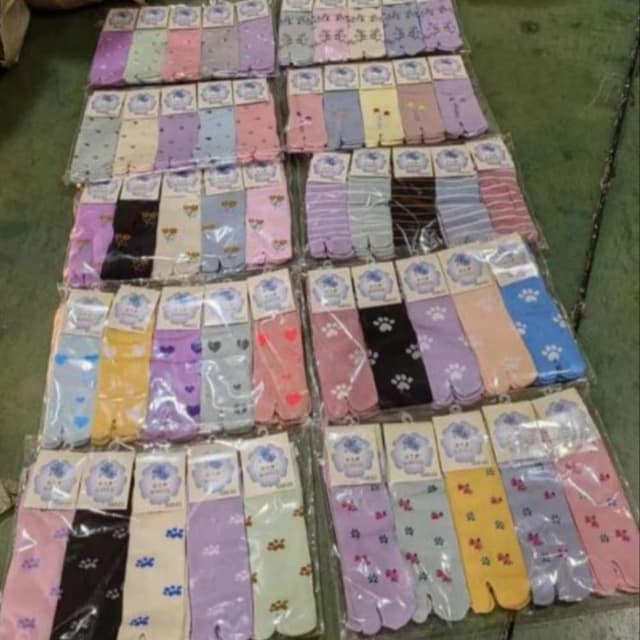 Various pastel colors including pink, purple, blue, yellow, and green, with black and white accents. Toe Socks