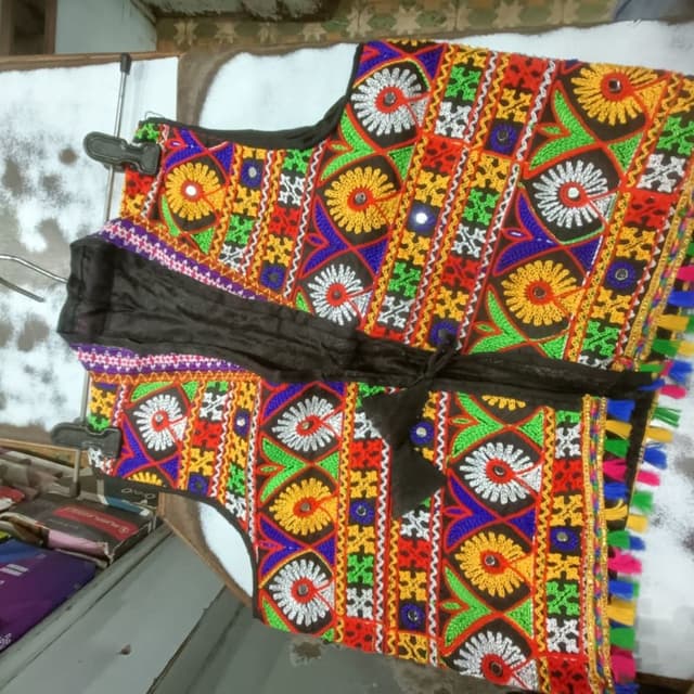 Multicolor, featuring a vibrant combination of red, orange, yellow, green, blue, and white, with a black base and accents. Vest/Jacket