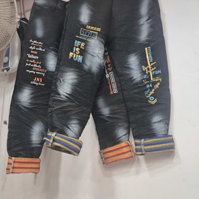 Black with contrasting cuff colors of orange, yellow, and blue Jeans