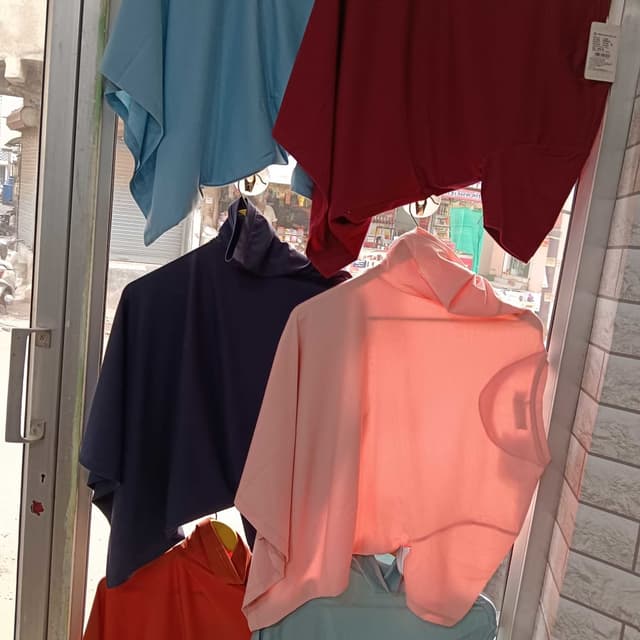 Various solid colors including blue, burgundy, navy, peach, and orange. T-shirts or Tops