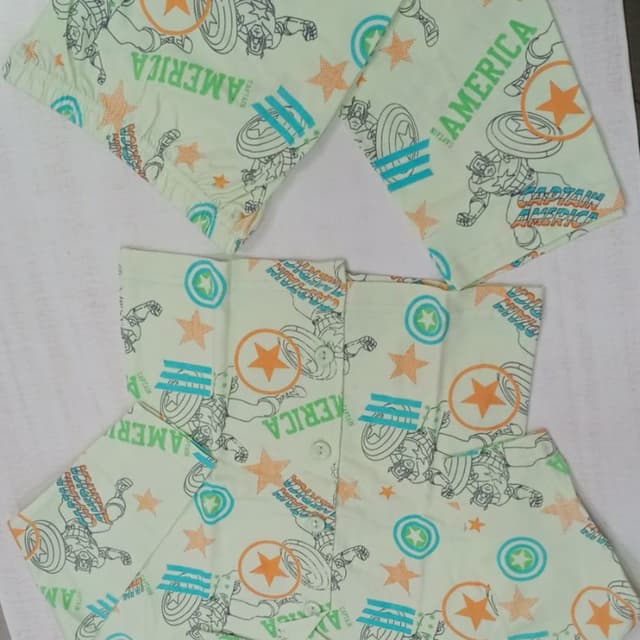 Light green base with orange, blue, and black accents. Pajama set