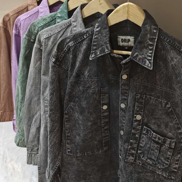 Various, including brown, purple, green, and a dark charcoal wash. Jacket