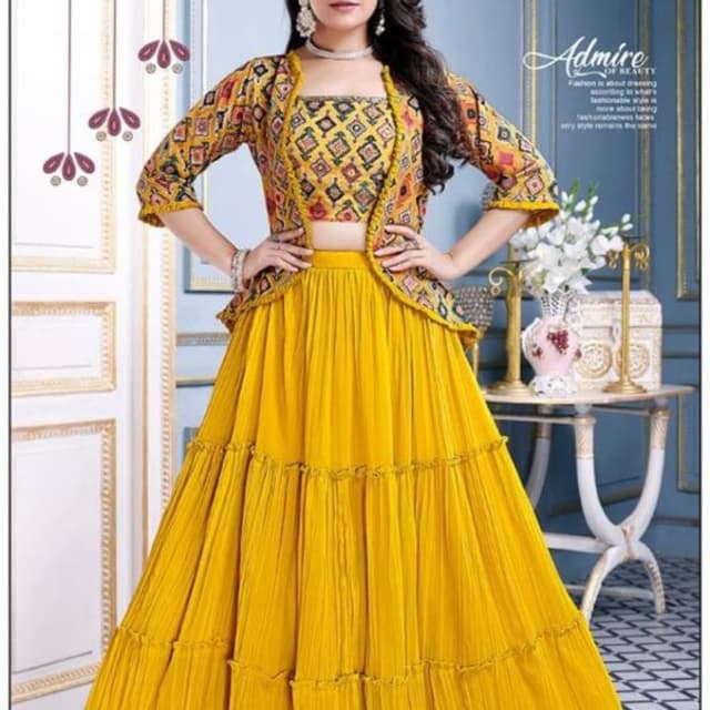 Mustard yellow, with accents of red, orange, and black in the jacket print. Lehenga Choli set with a jacket