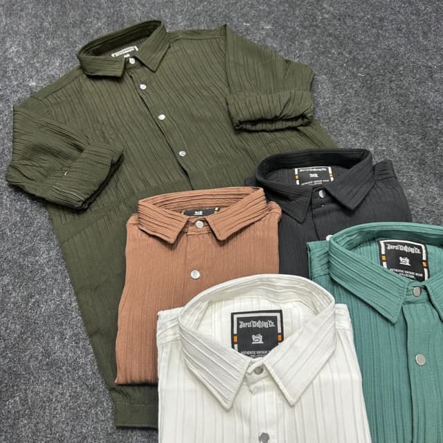 Various solid colors including olive green, brown, black, teal, and white. Shirts