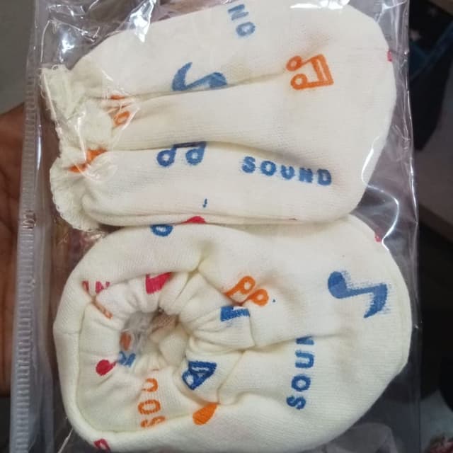 Off-white with blue, orange, and red accents Baby Mittens