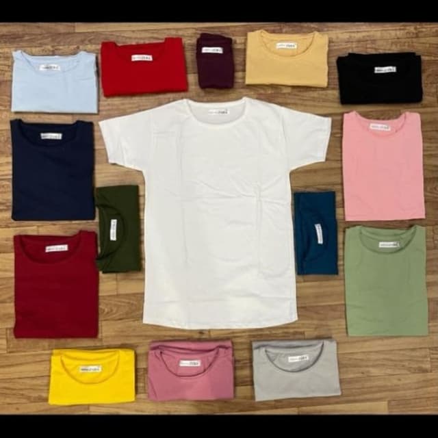 Various solid colors including white, blue, red, yellow, pink, green, and black. T-shirt