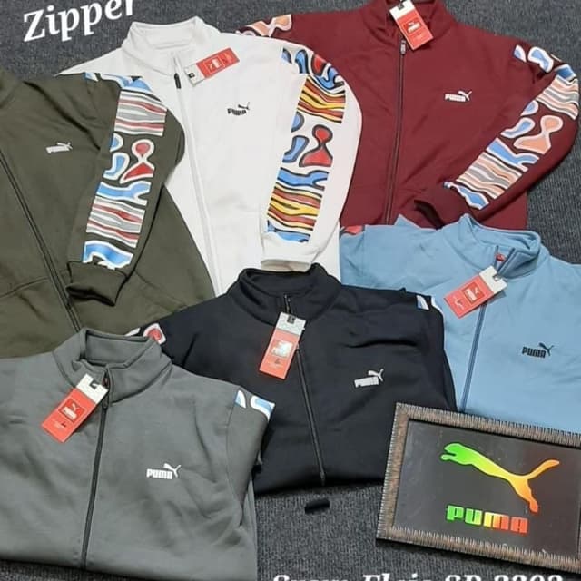 Various solid colors including white, black, gray, blue, maroon, and olive green, with colorful abstract patterns on the sleeves. Track Jackets