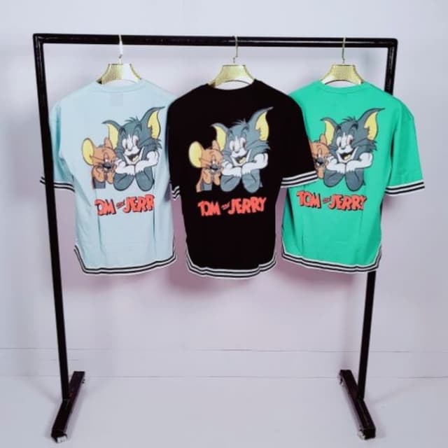 Various pastel colors: light blue, black, and mint green with multi-colored graphic print. T-shirt