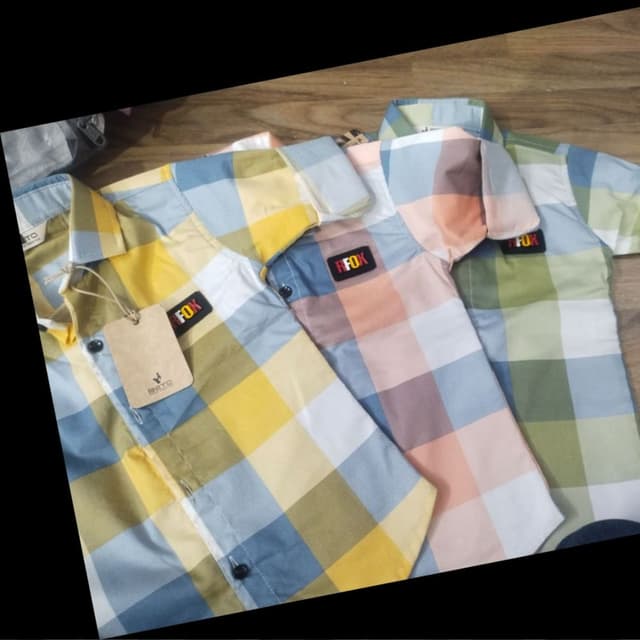 Yellow, blue, white, and green in a check pattern. Shirt