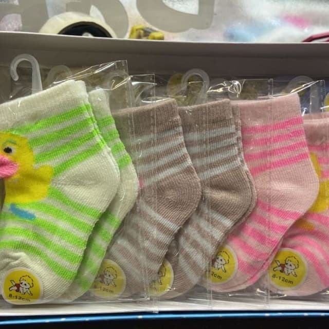 Various, including white, green, brown, pink, and yellow Socks