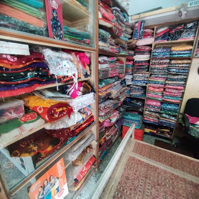 Various, including red, yellow, pink, blue, green, and white Sarees, Dress materials