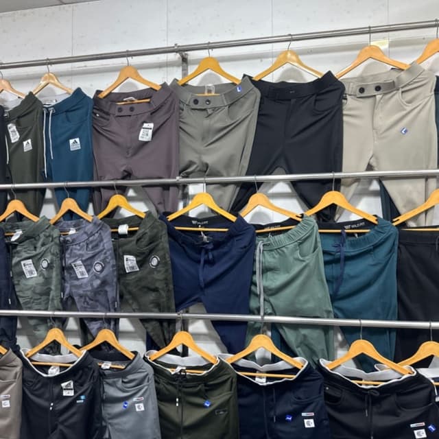 Various solid colors including black, navy, green, grey, and khaki, as well as camouflage patterns. Pants