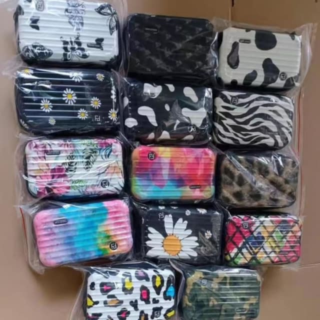 Various, including black and white, pink, blue, yellow, green, and a rainbow tie-dye. Mini Suitcase/Cosmetic Case