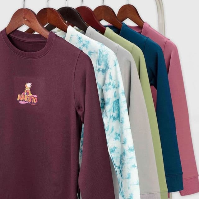 Various solid colors including maroon, light green, dark teal, and a pinkish-red, with a tie-dye pattern in blue and white on one item. Sweatshirts