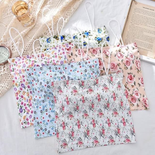 Various floral patterns with pastel and bright colors, including pink, blue, white, and green Shopping Bags