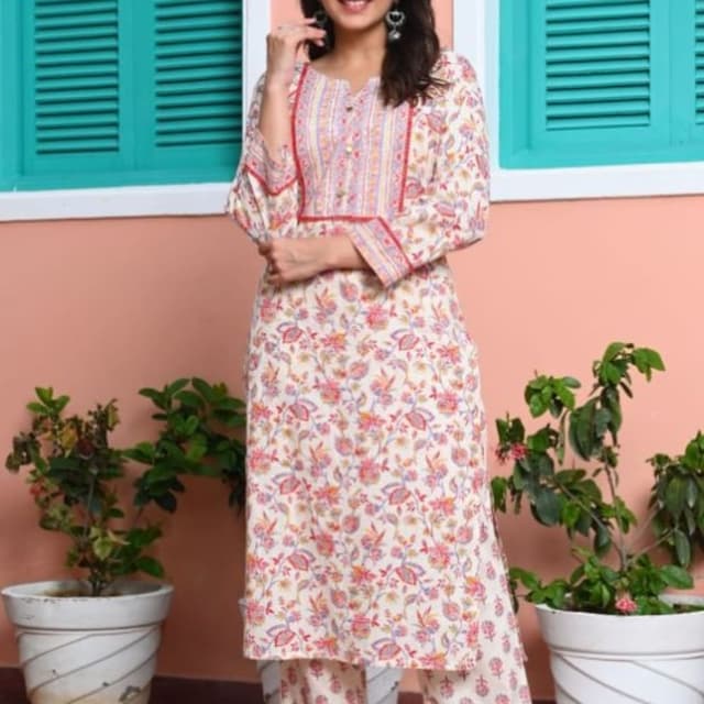 Off-white base with pink, purple, and blue floral print, accented with red trim Kurta with matching palazzo pants