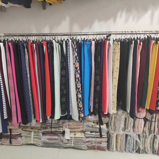 Various, including solid colors like black, blue, red, pink, and yellow, and patterned fabrics with floral and striped designs. Pants