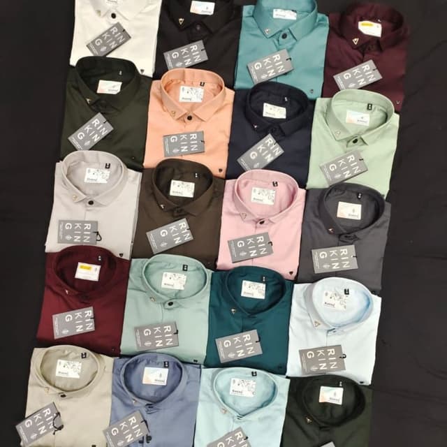 A variety of solid colors including white, black, dark green, salmon, navy, mint green, maroon, light grey, chocolate brown, pink, dark grey, teal, light blue, and olive green. Shirt