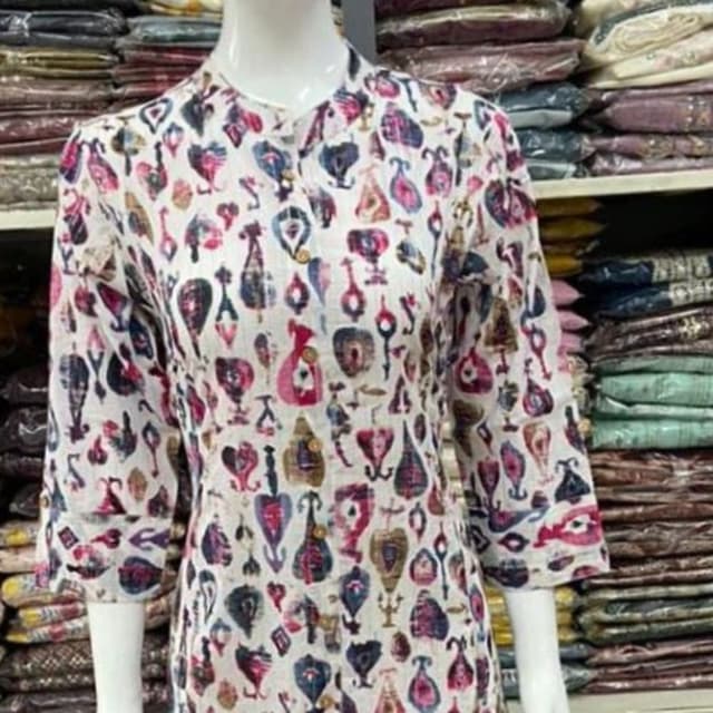 White base with a multi-colored print including shades of pink, blue, brown, and gold. Kurti