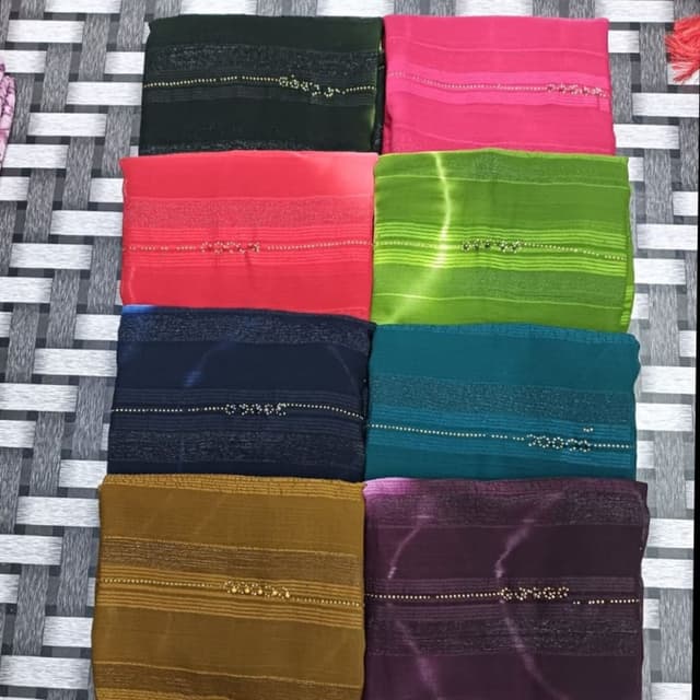 Variety of colors including green, pink, red, blue, teal, purple, and gold Saree or similar fabric