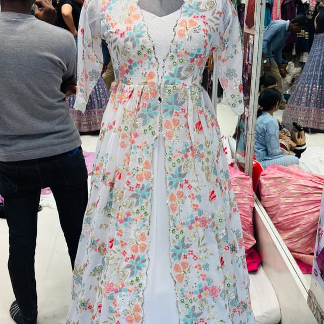 White, with pastel shades of pink, orange, blue, and green, along with gold and silver accents Dress