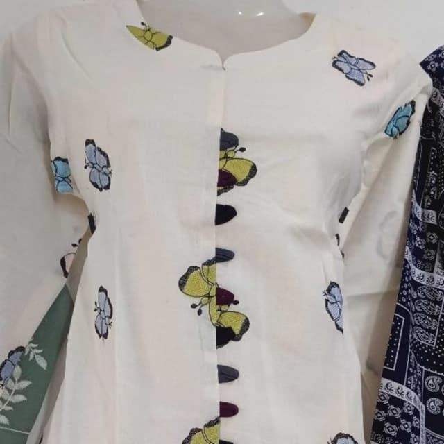 Off-white with multi-colored accents (yellow, blue, black, maroon) Shirt/Top