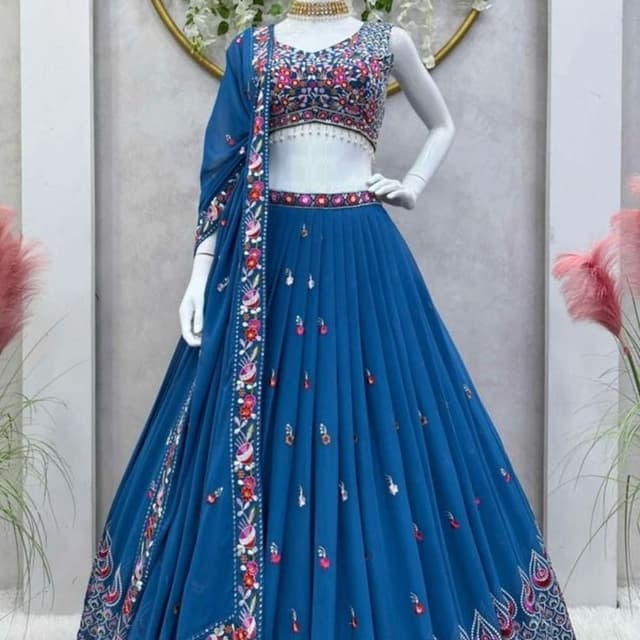 Blue, with multi-colored embroidery and embellishments. Lehenga Choli