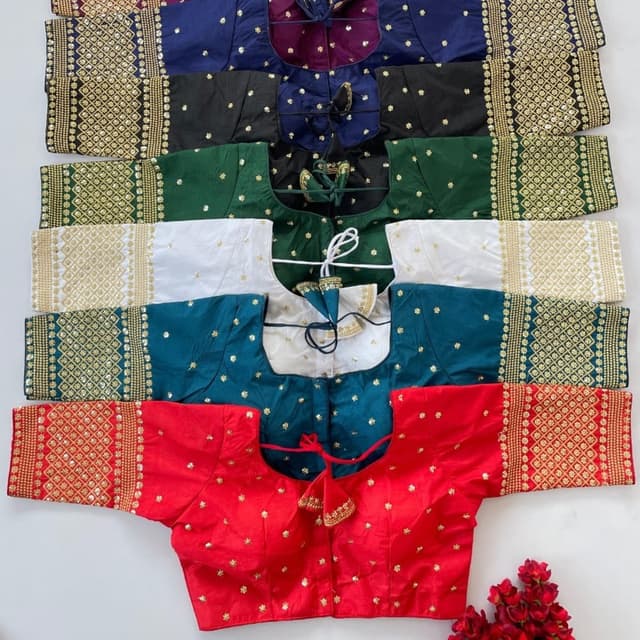 Various, including red, teal, white, green, black, and navy. Each top features embellishments in gold. Blouse