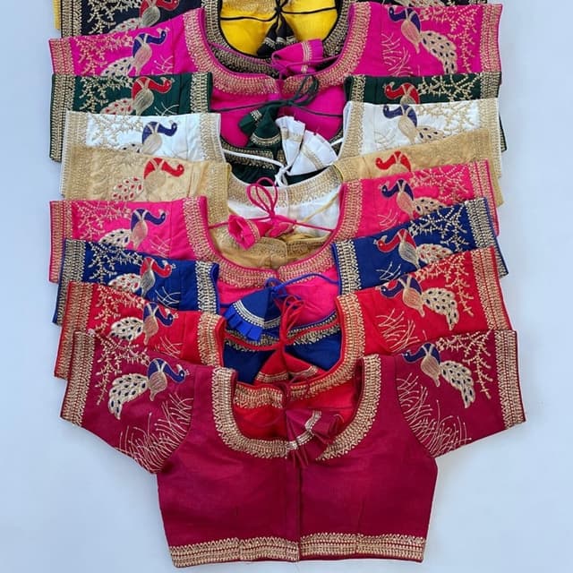 Various vibrant colors including pink, red, blue, green, white, gold, and black with gold embroidery accents. Blouse