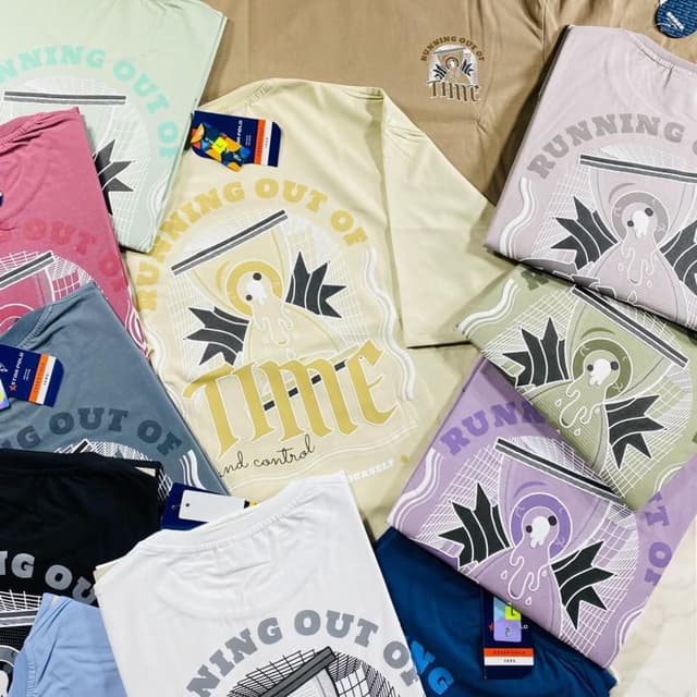Various pastel colors including beige, pink, green, purple, blue, white, and black with variations in shade. The print features a combination of black, white, and yellow. T-shirt