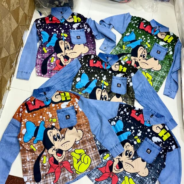 Various, including blue, brown, green, purple, and black backgrounds with cartoon characters in vibrant colors like yellow, red, and blue. Shirt