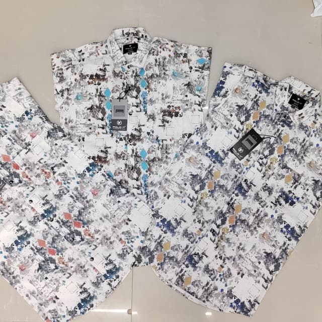 White, with a multicolor abstract pattern including blues, grays, and touches of orange and yellow Shirt